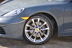 Close-up of high-performance car accessories like alloy wheels and sport pedals.
