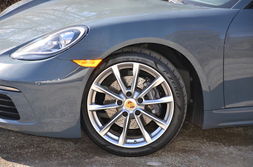 Close-up of high-performance car accessories like alloy wheels and sport pedals.