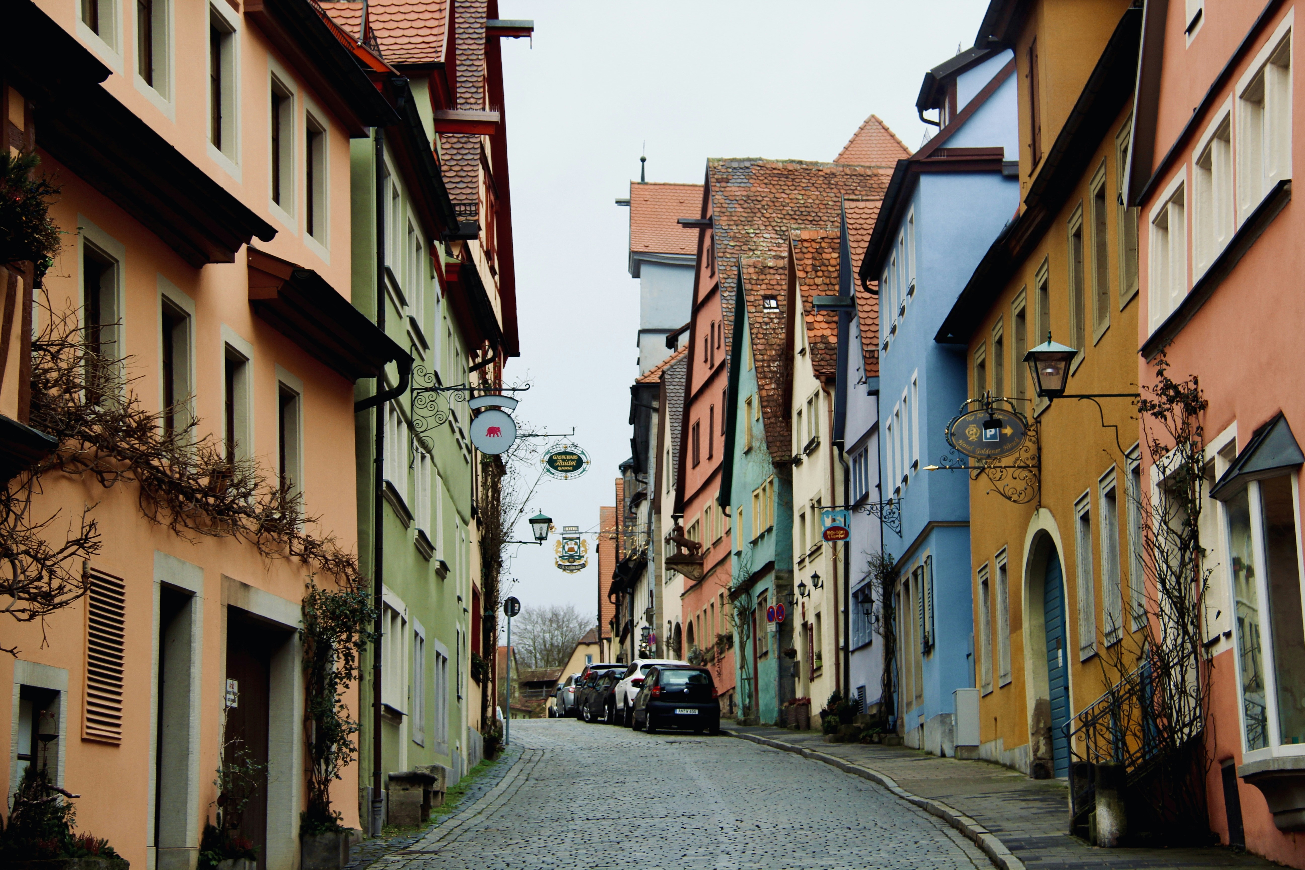a car is parked on the side of a narrow street, 