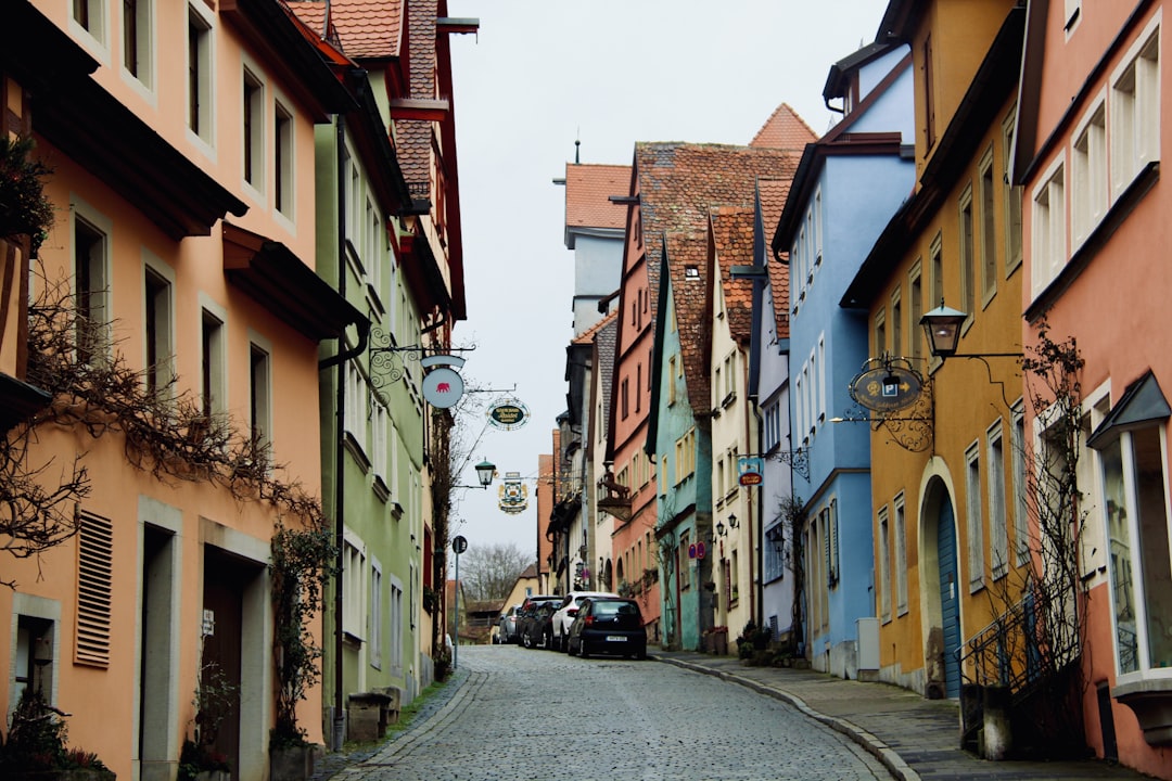 a car is parked on the side of a narrow street,