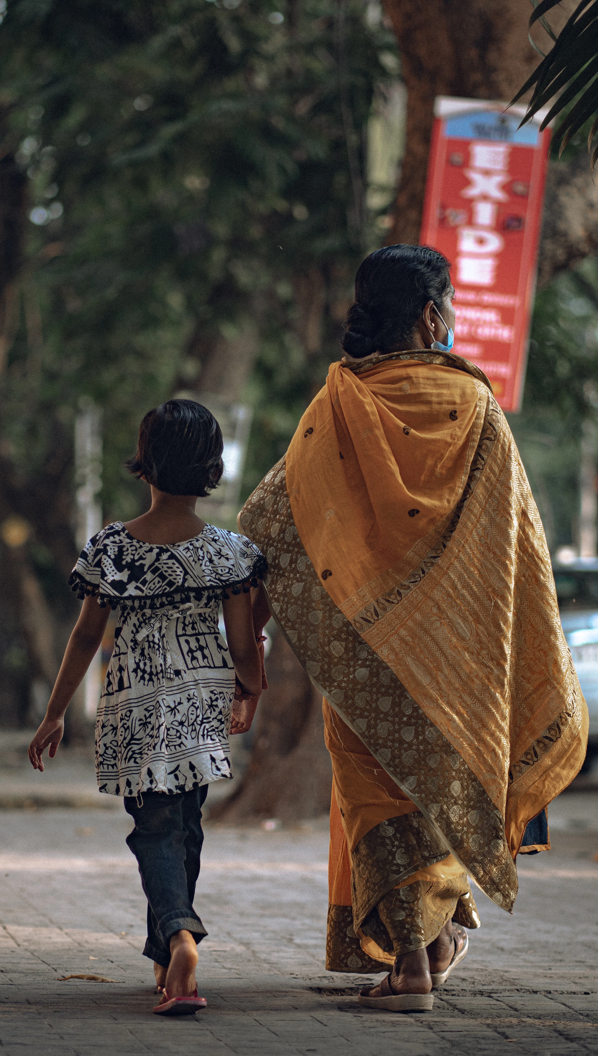 a woman and child walking down a street