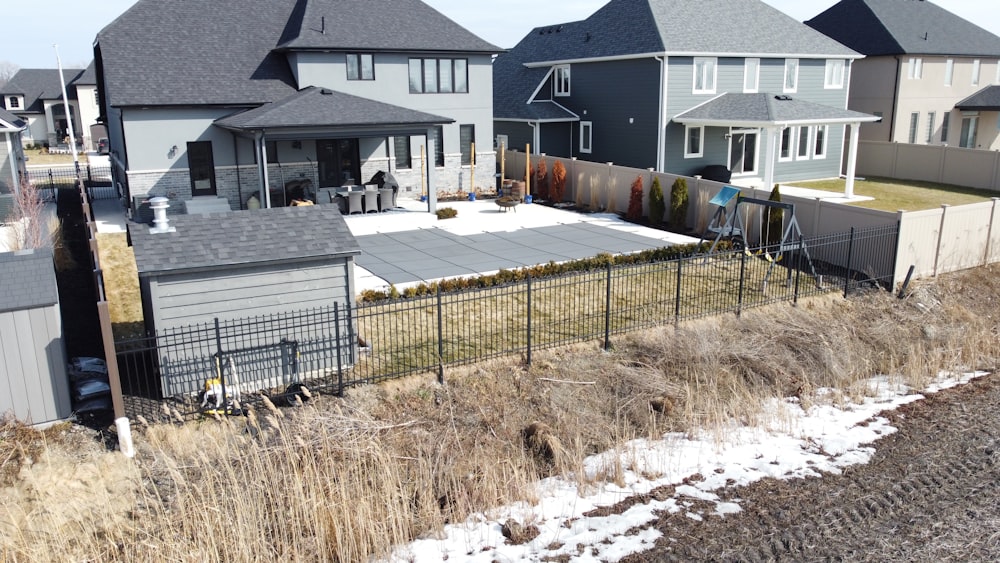 a row of houses with a fence in front of them