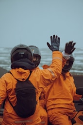 a couple of people riding on the back of a motorcycle
