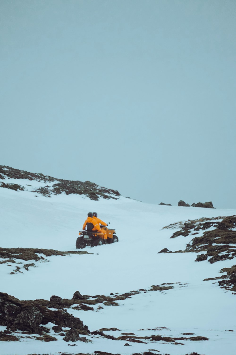 a person riding a four wheeler in the snow