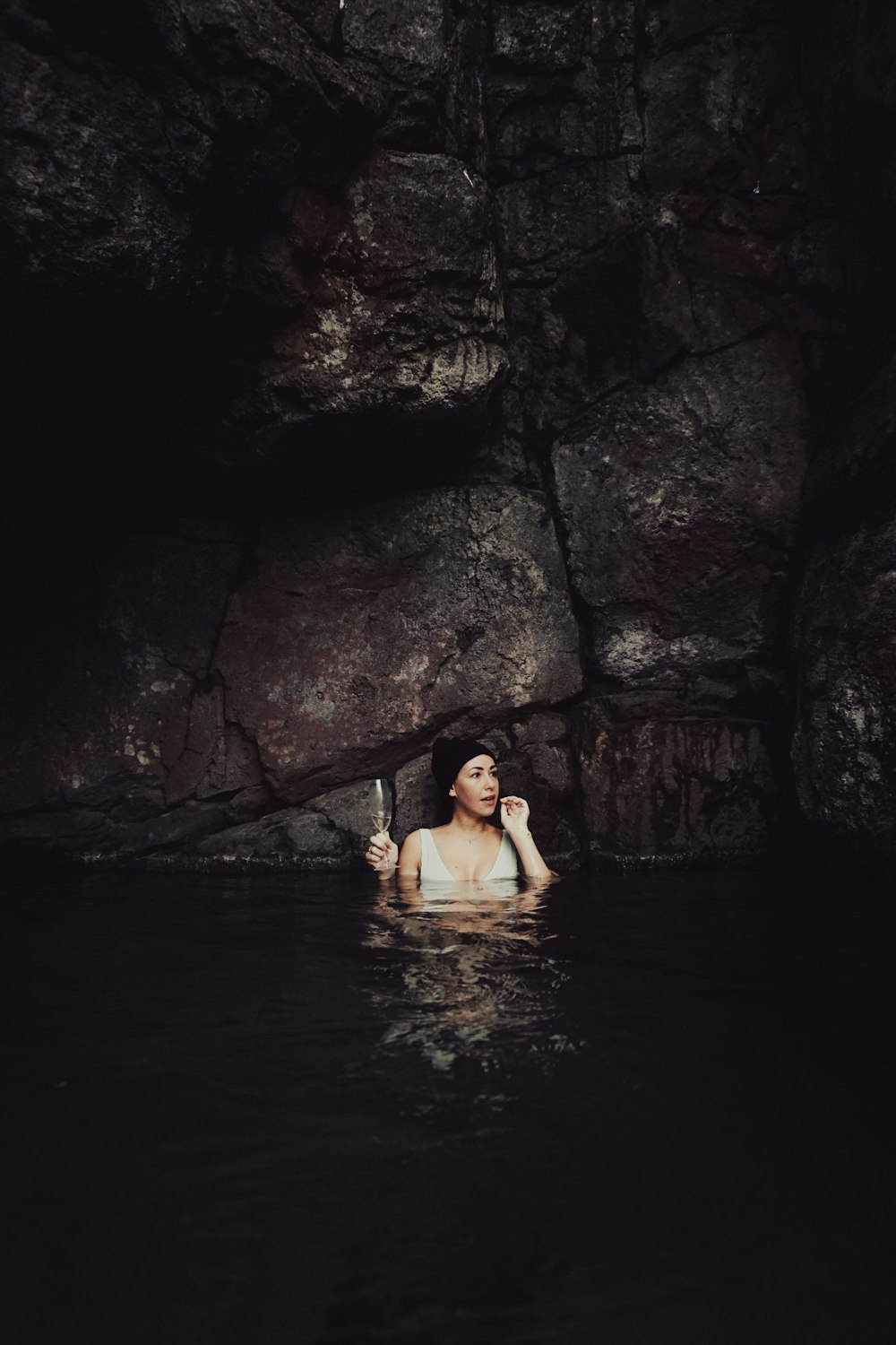 a woman in a body of water holding a knife