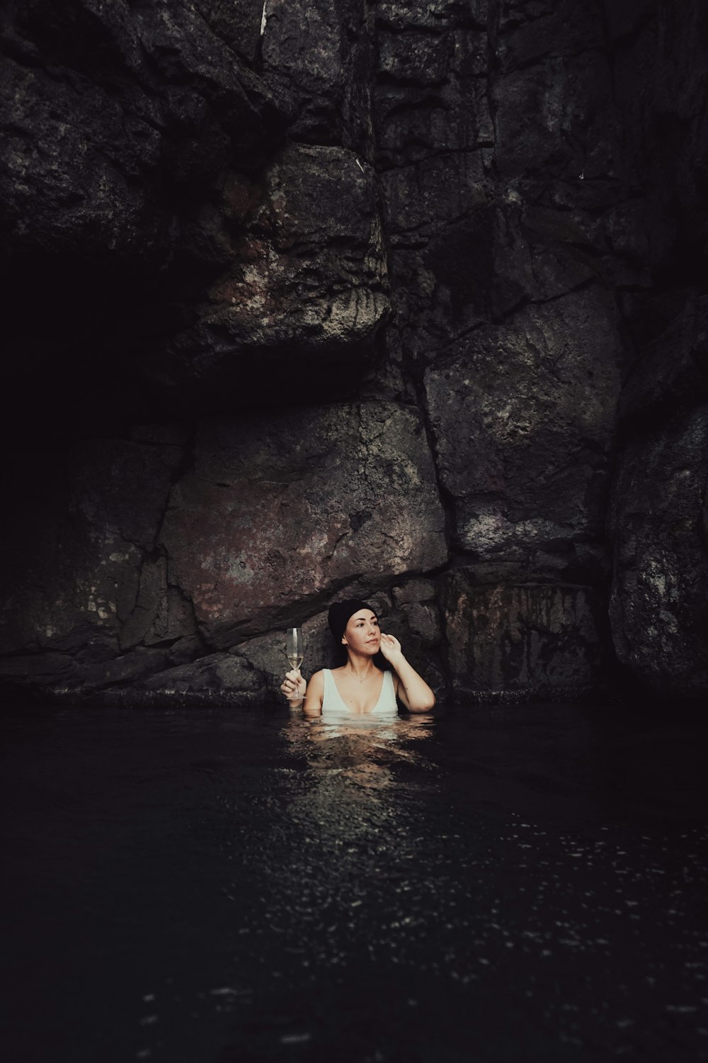 a woman in a body of water holding a knife