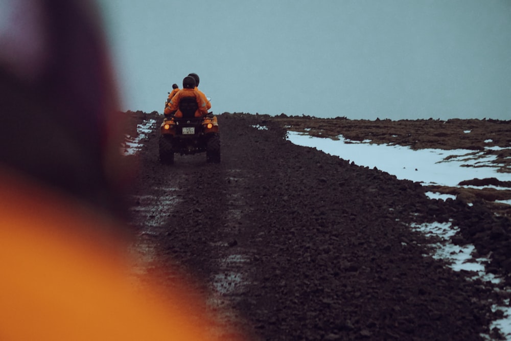 a person riding a four wheeler on a dirt road