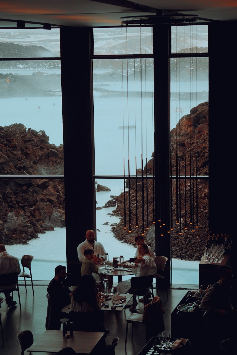 a group of people sitting at a table in front of a window