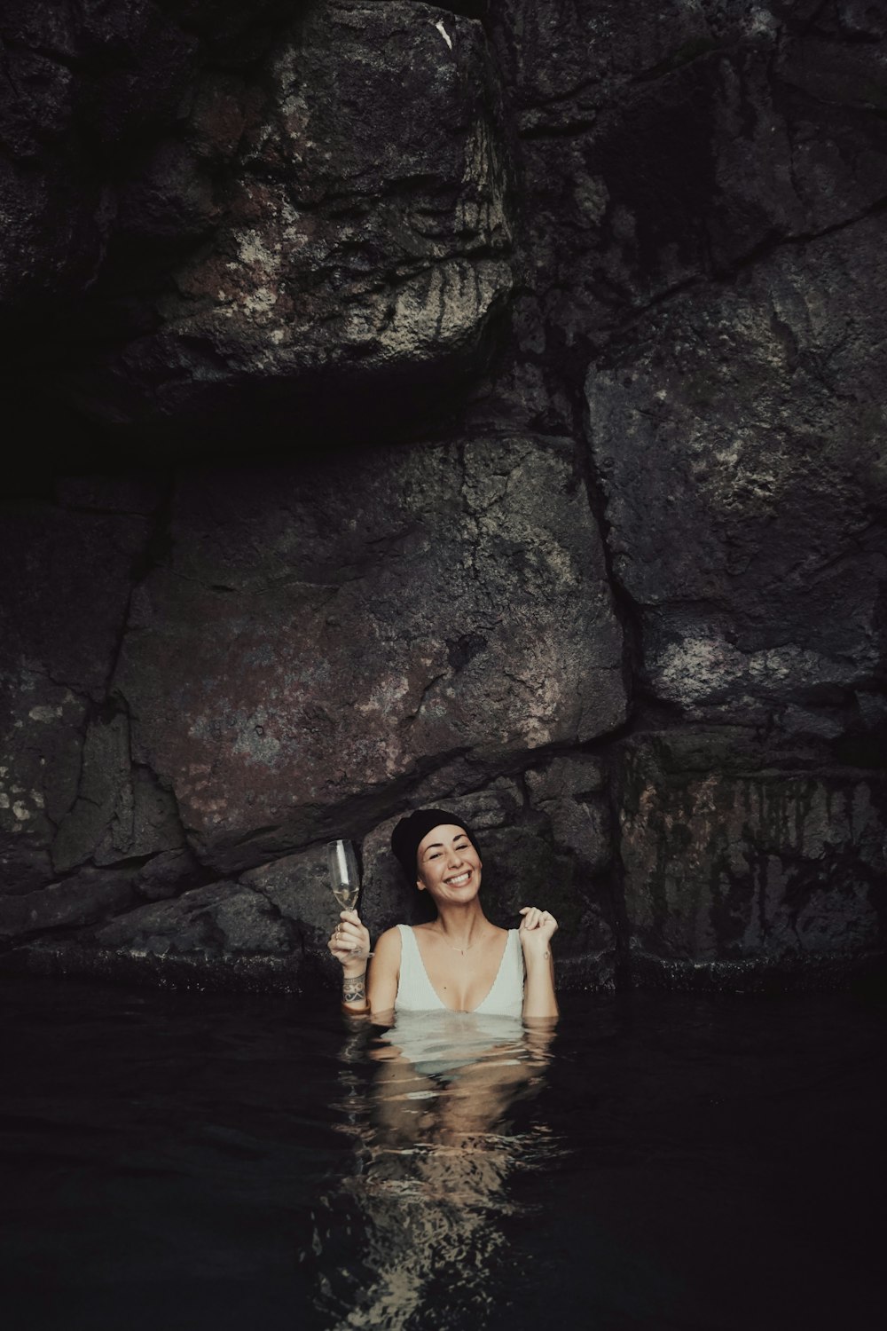 a woman in a body of water holding a knife
