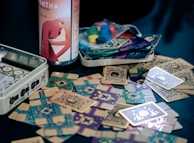 a can of beer sitting next to a pile of playing cards