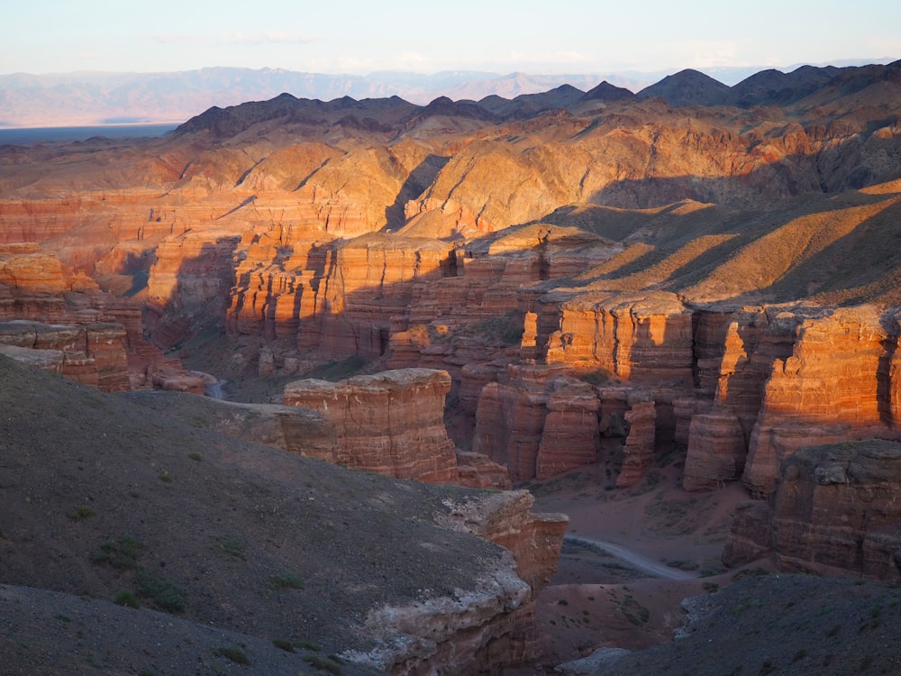 the sun is setting over the canyons in the desert