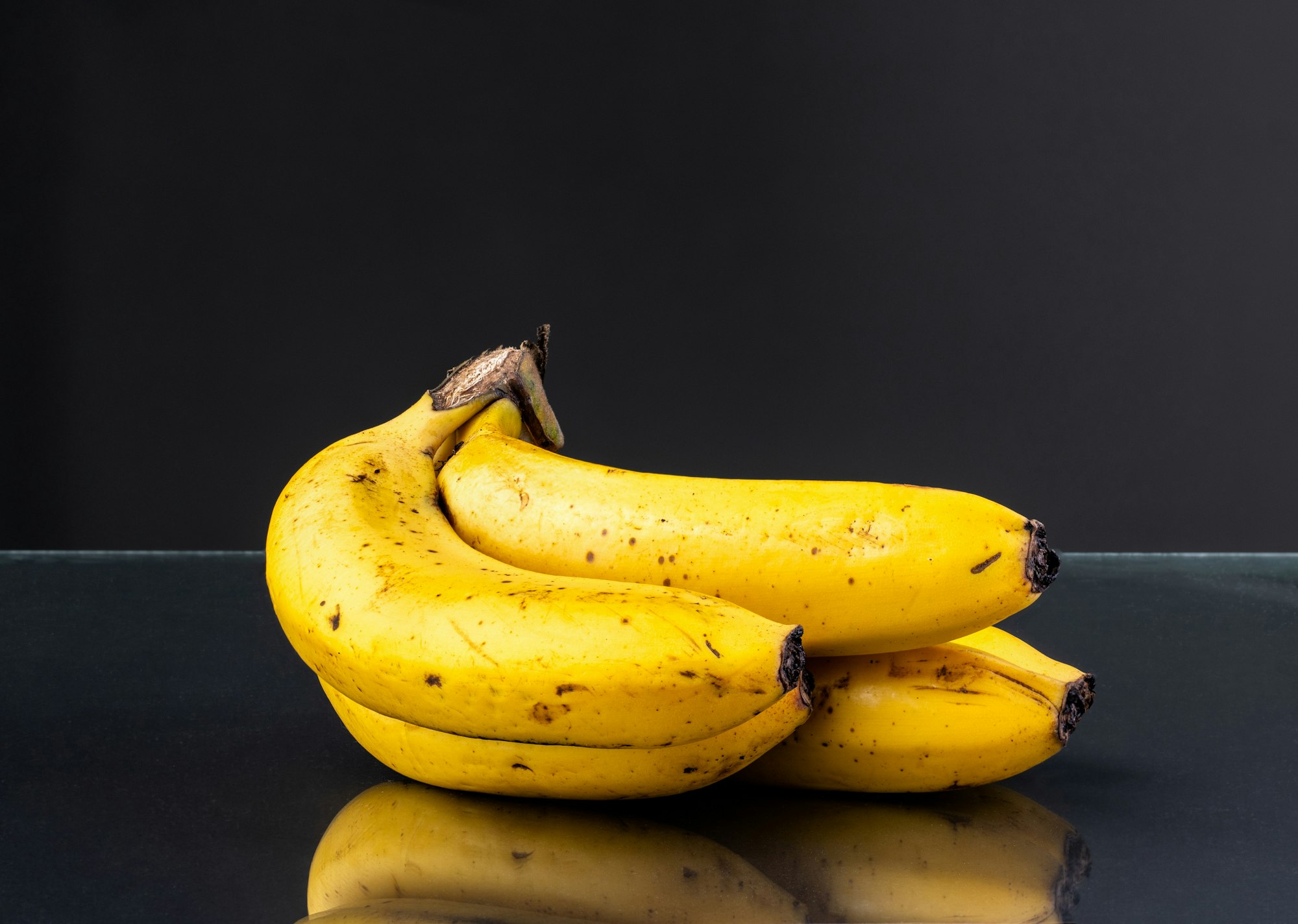 Closeup shot of the texture and color of bananas on dark background