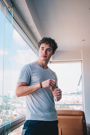 A worker enjoying Stellarybites snack during a coffee break with a modern city view.
