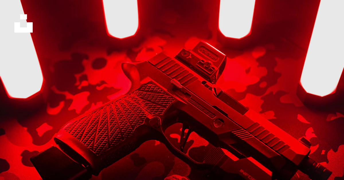 A red light gun laying on a black background photo – Free Handgun Image ...