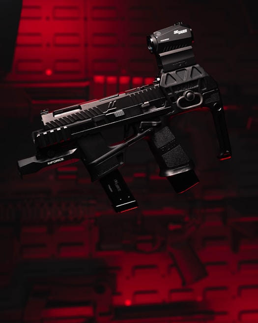 A black firearm with a tactical light attachment is set against a striking red background. The image captures the details of the weapon, revealing textured grips and a sleek design.