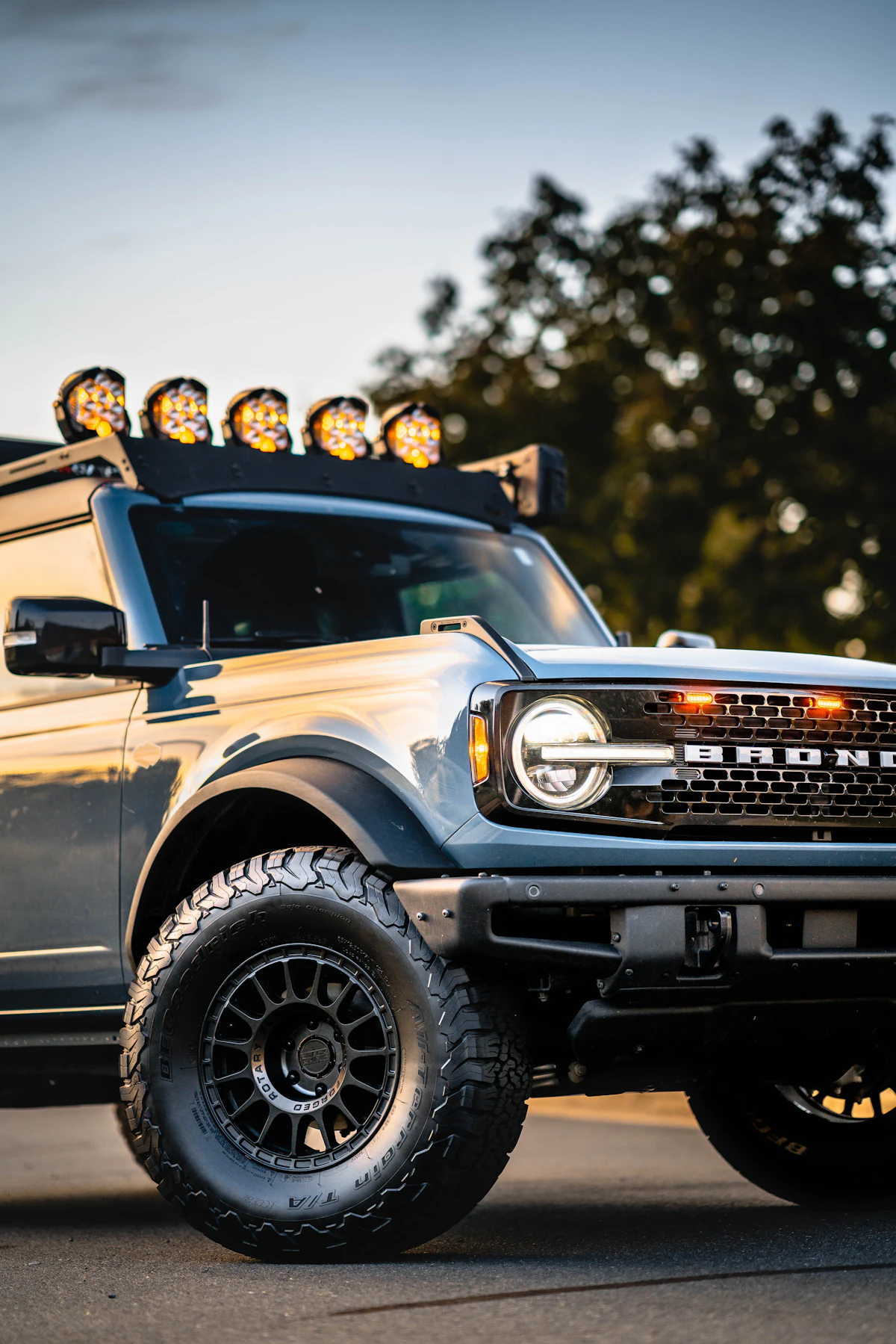 Ford Bronco with roof lights at sunset