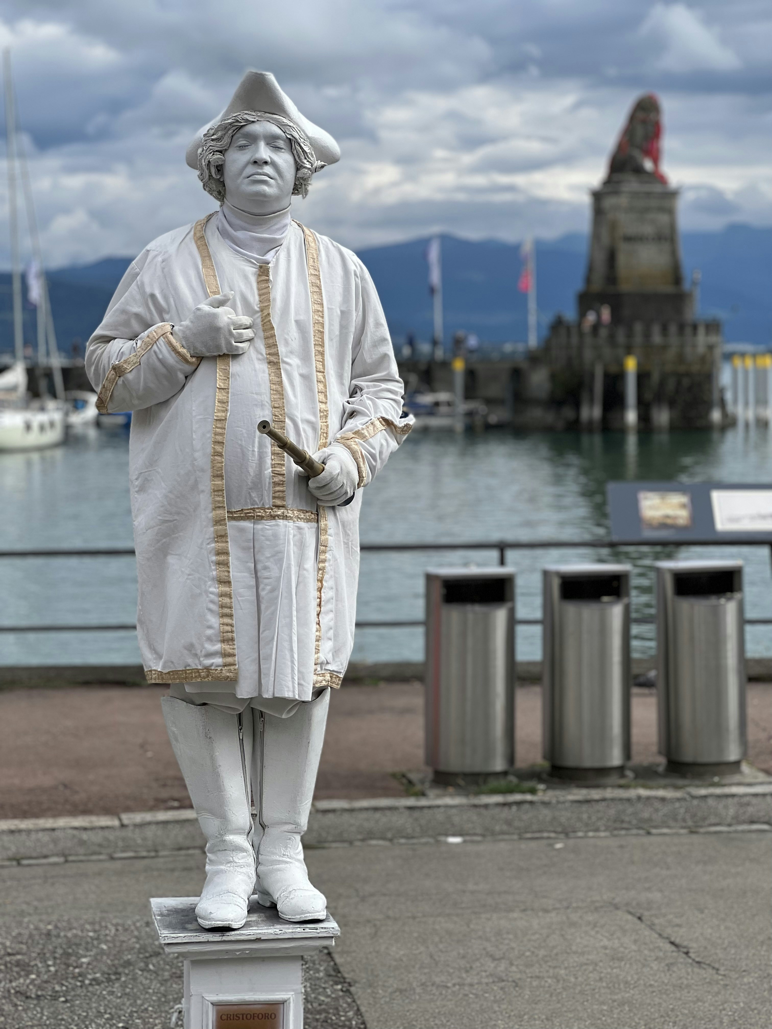 a statue of a man with a hat and a cane