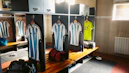a locker room with a number of shirts hanging on the wall