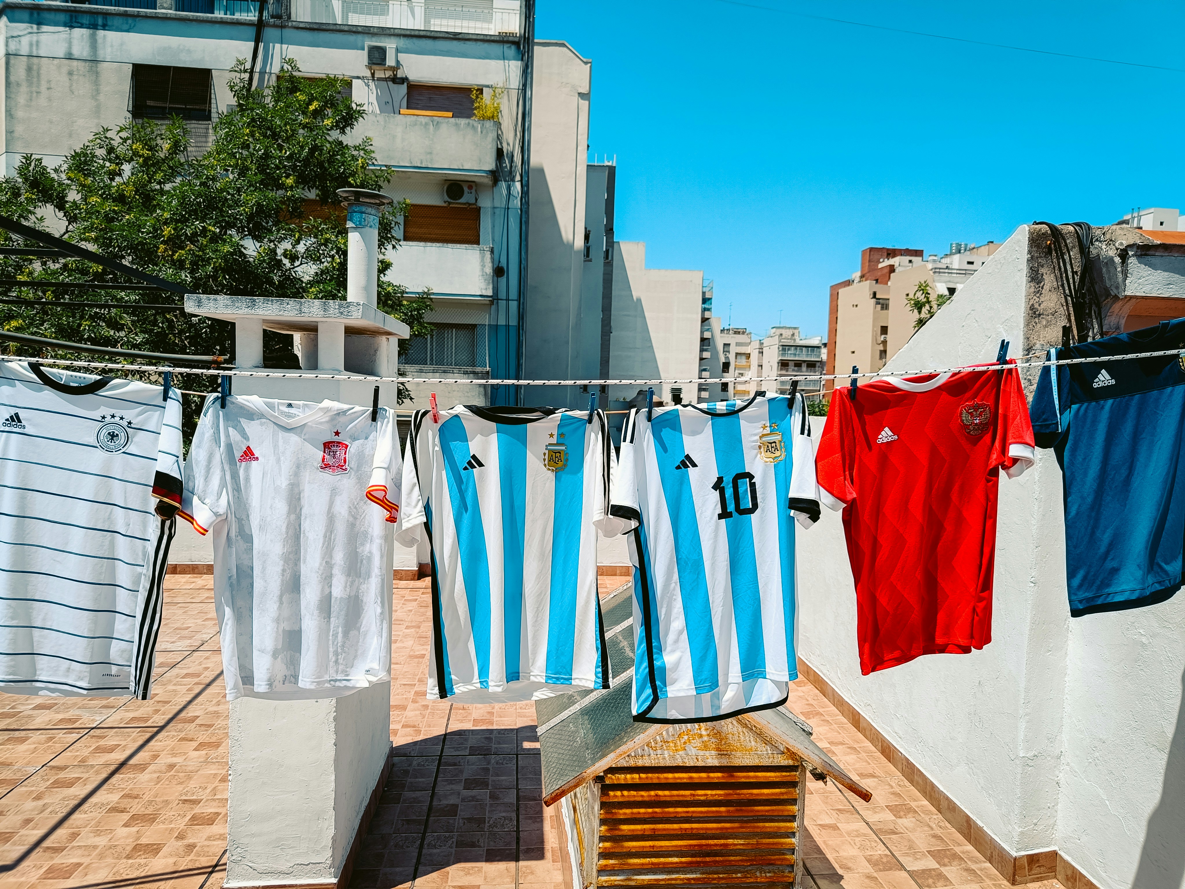 a row of clothes hanging on a clothes line, 