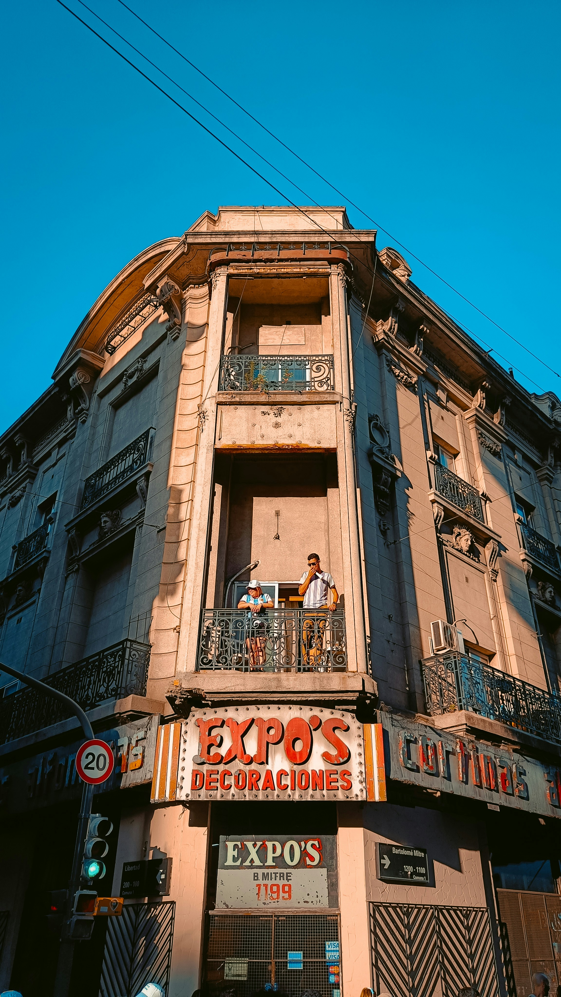 a tall building with people standing on the balconies