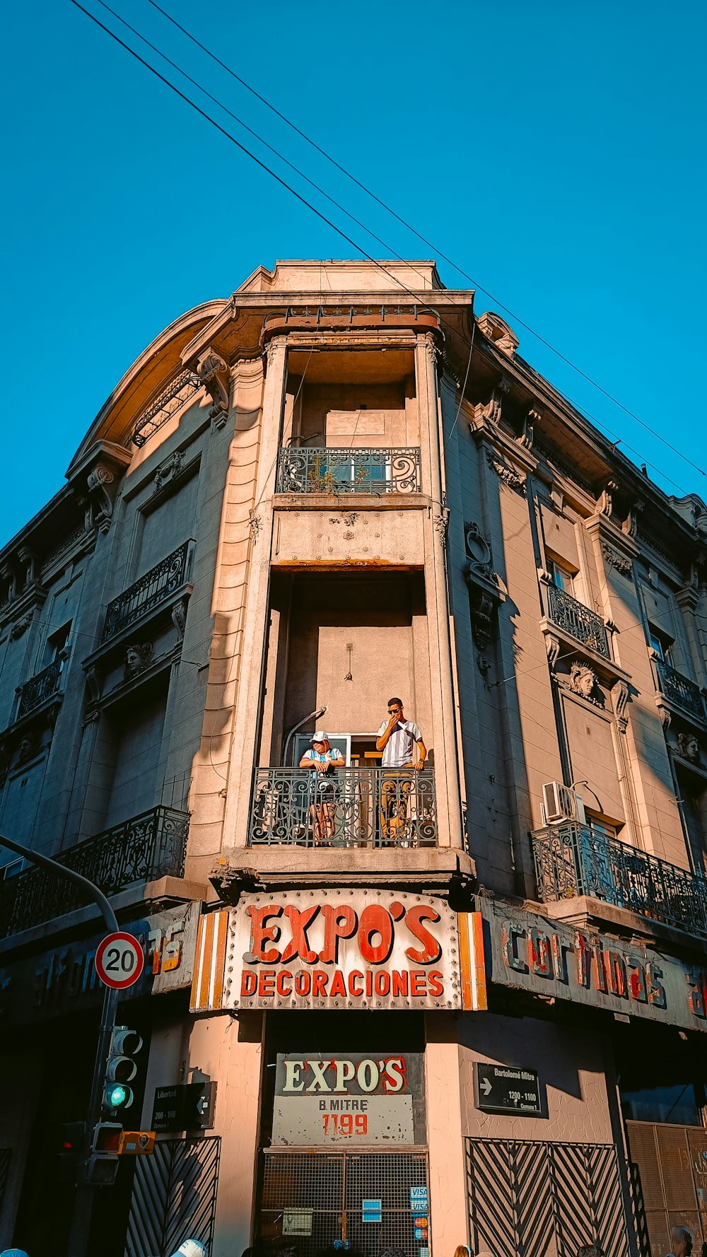 a tall building with people standing on the balconies