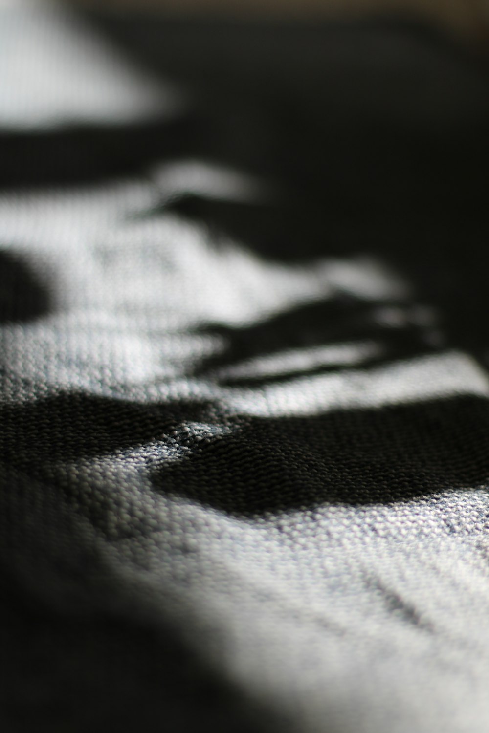 a close up of a black and white checkered blanket