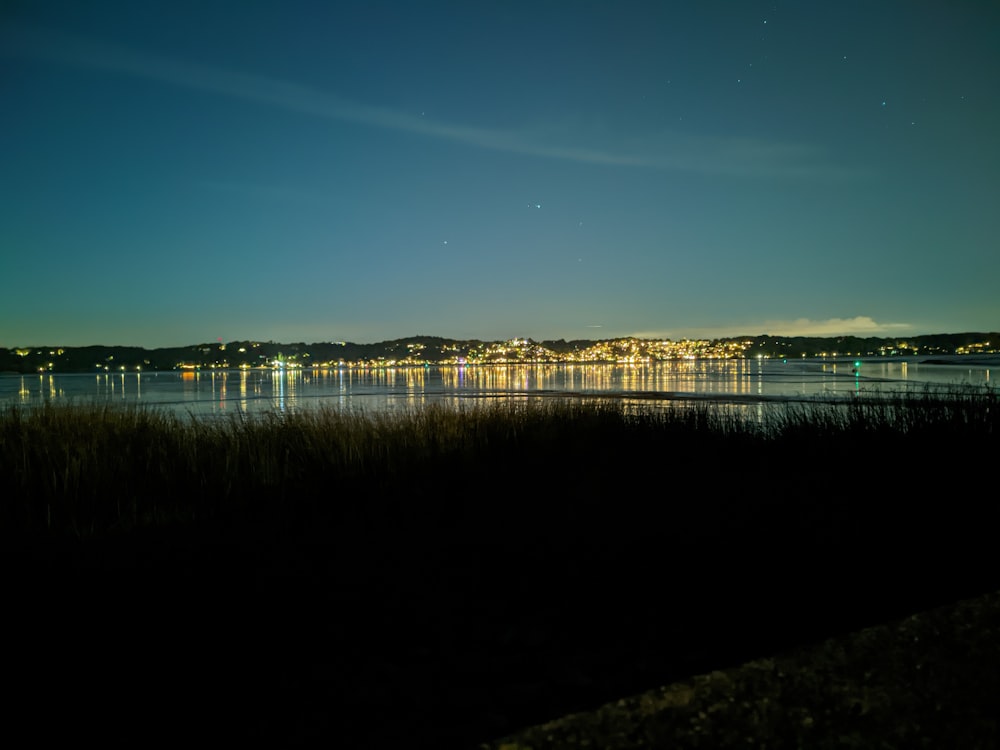 a body of water with a city in the background