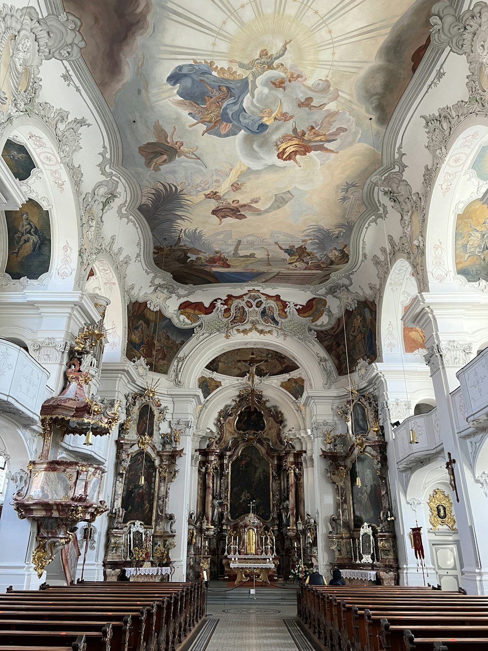 the interior of a church with painted ceilings and pews