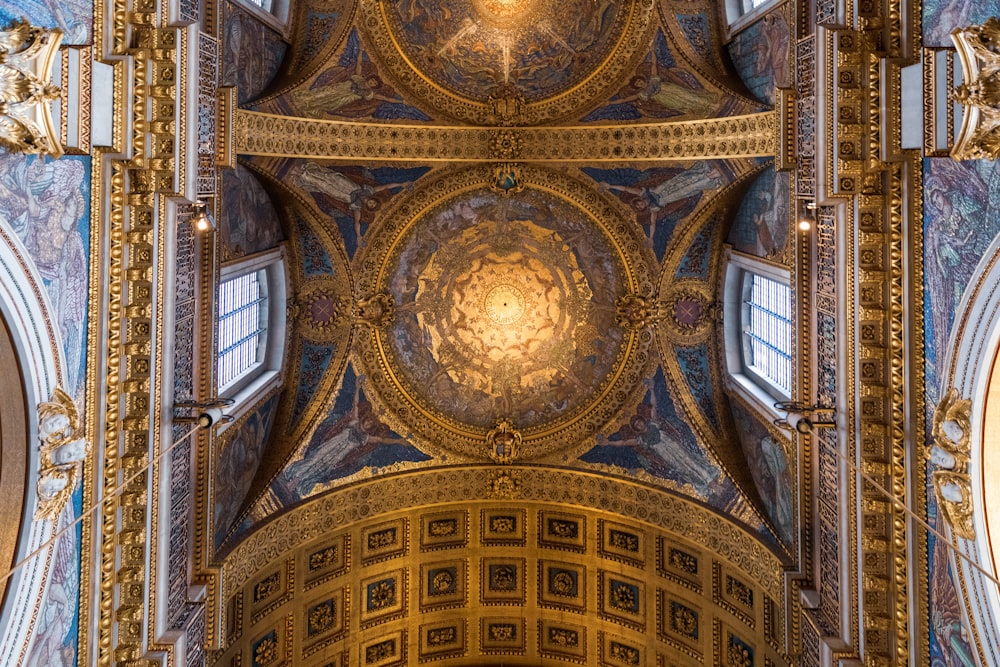 the ceiling of a large church with ornate designs