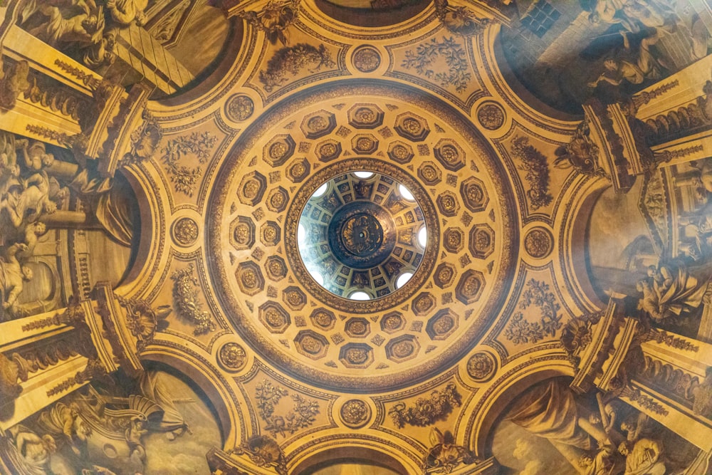 the ceiling of a building with many paintings on it