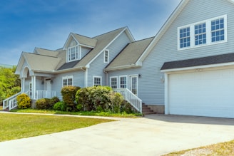 a white house with a large driveway in front of it