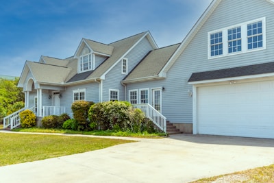 a white house with a large driveway in front of it