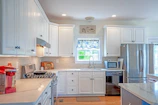Modern kitchen in the family suite equipped with stainless steel appliances.