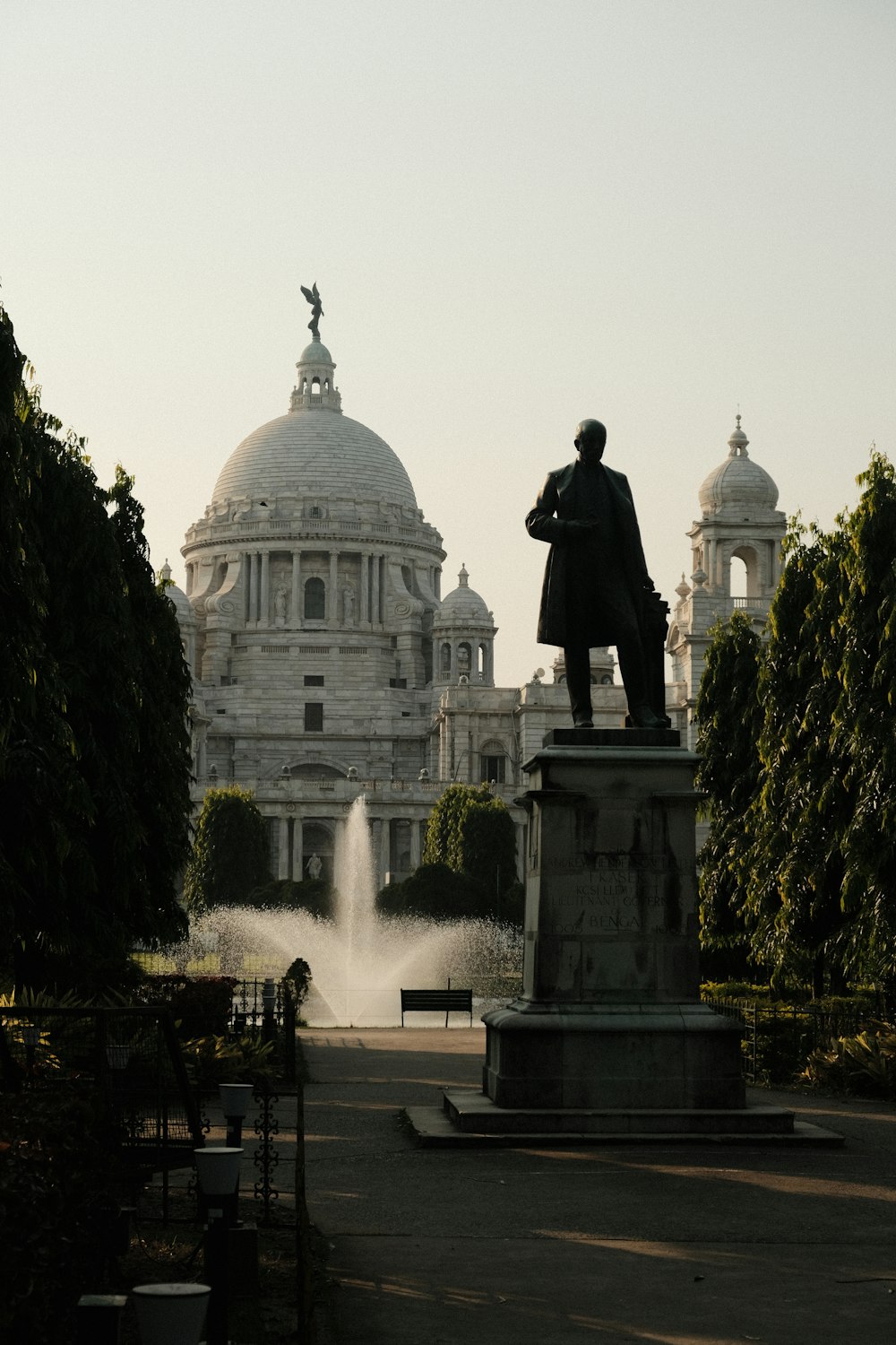 a statue of a man standing in front of a building