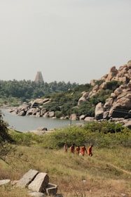 A group of happy travelers sharing a peaceful moment by a temple riverbank.