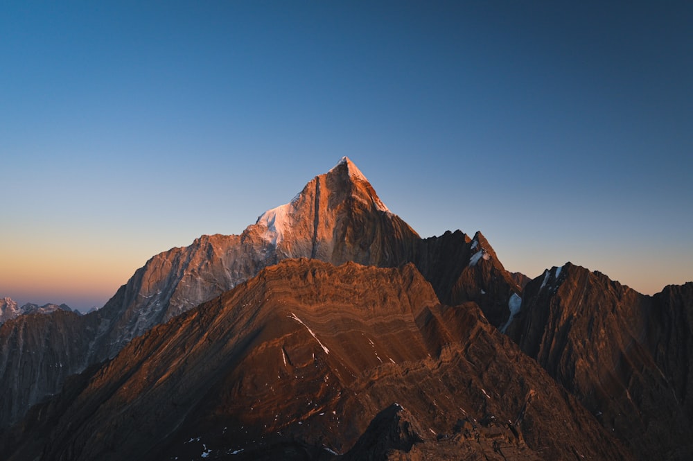 a view of the top of a mountain at sunset