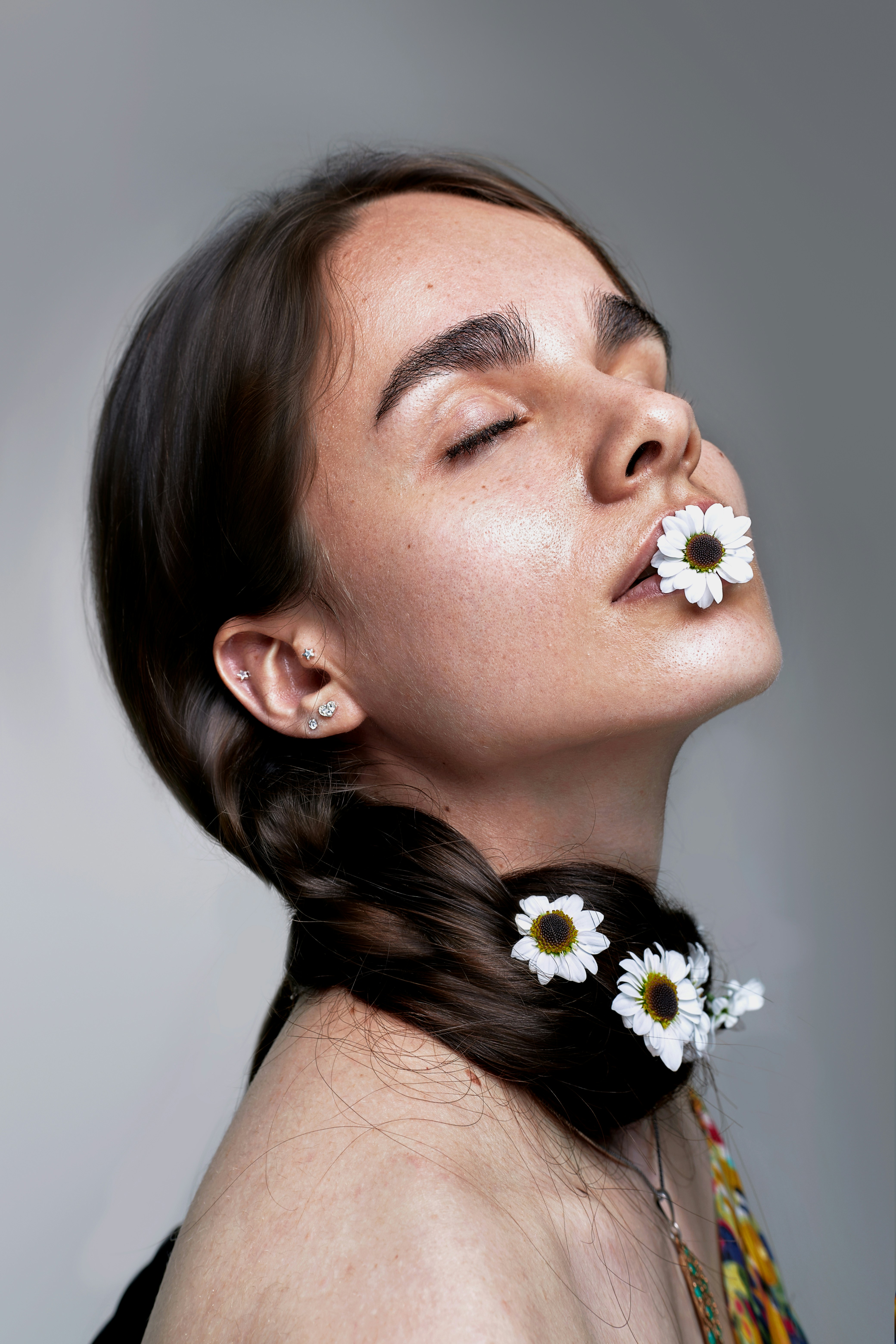 a woman with a flower in her mouth