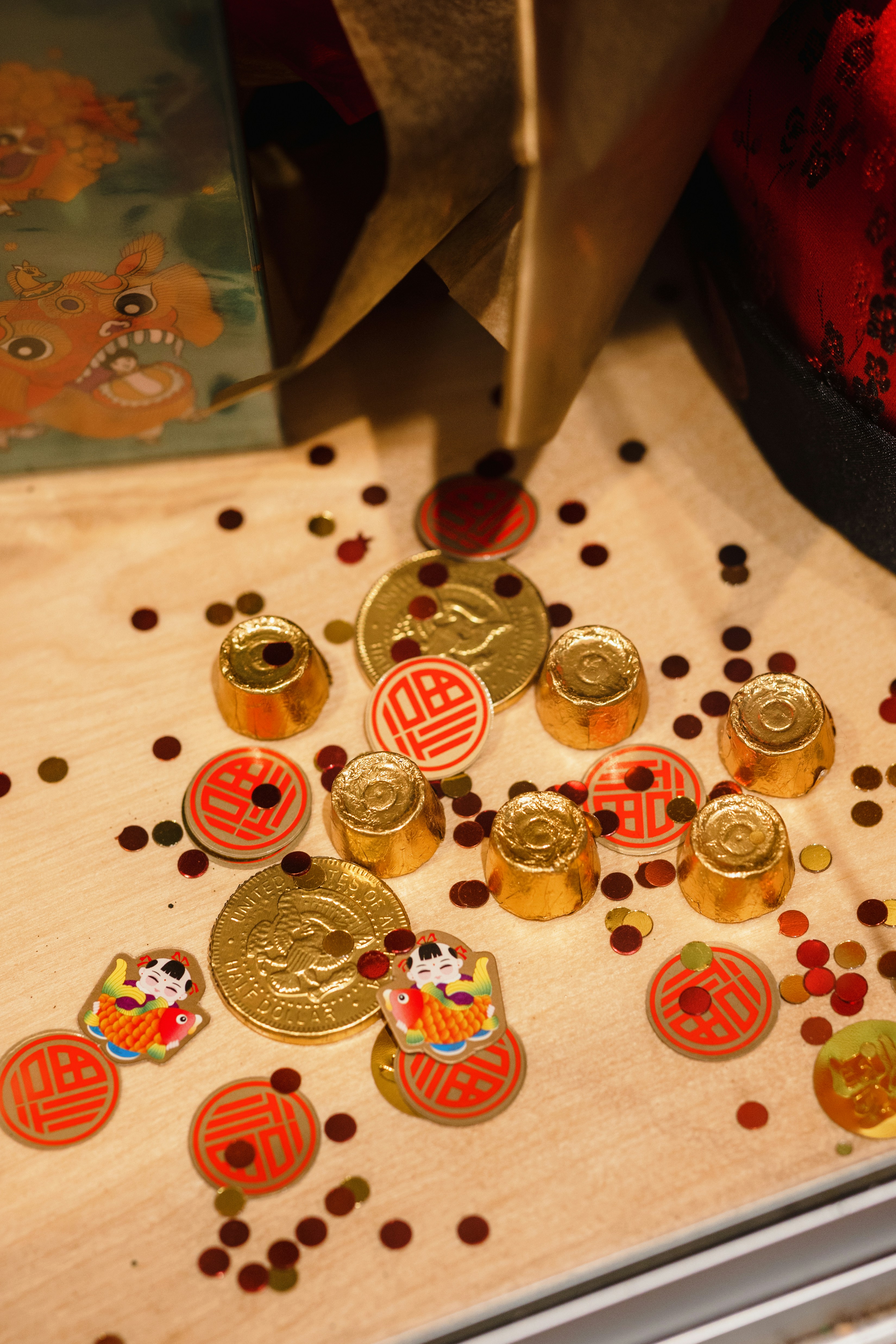 a wooden table topped with lots of gold coins