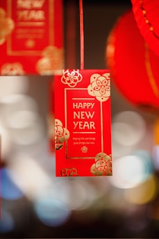 a red new year's card hanging from a string