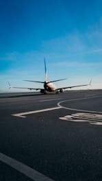 An airplane undergoing testing on a runway with a clear blue sky.