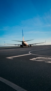 An airplane undergoing testing on a runway with a clear blue sky.