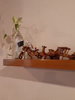 3D printed miniature models displayed on a sleek black shelf, highlighting fine craftsmanship.