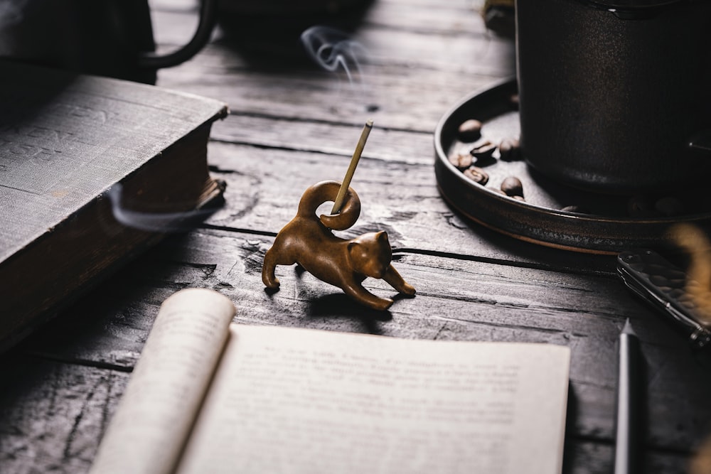 a figurine of a dog on a table next to a book