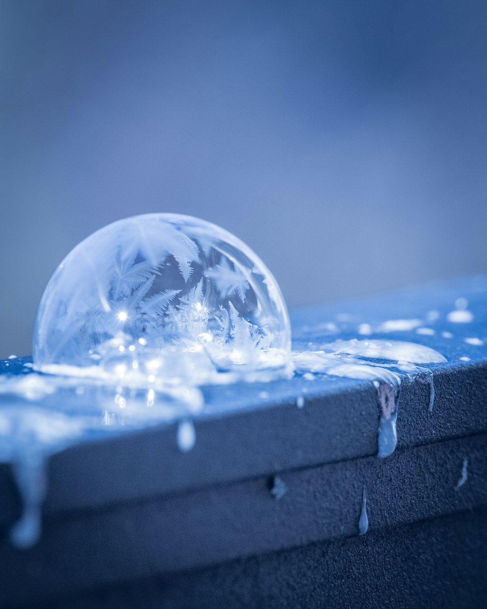 a crystal ball sitting on top of a blue box