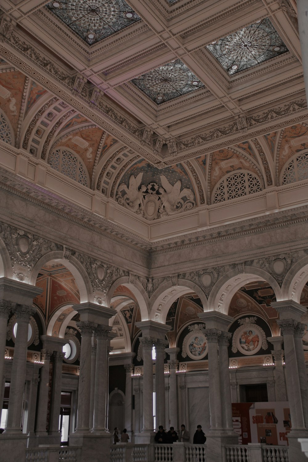 a large room with columns and a ceiling