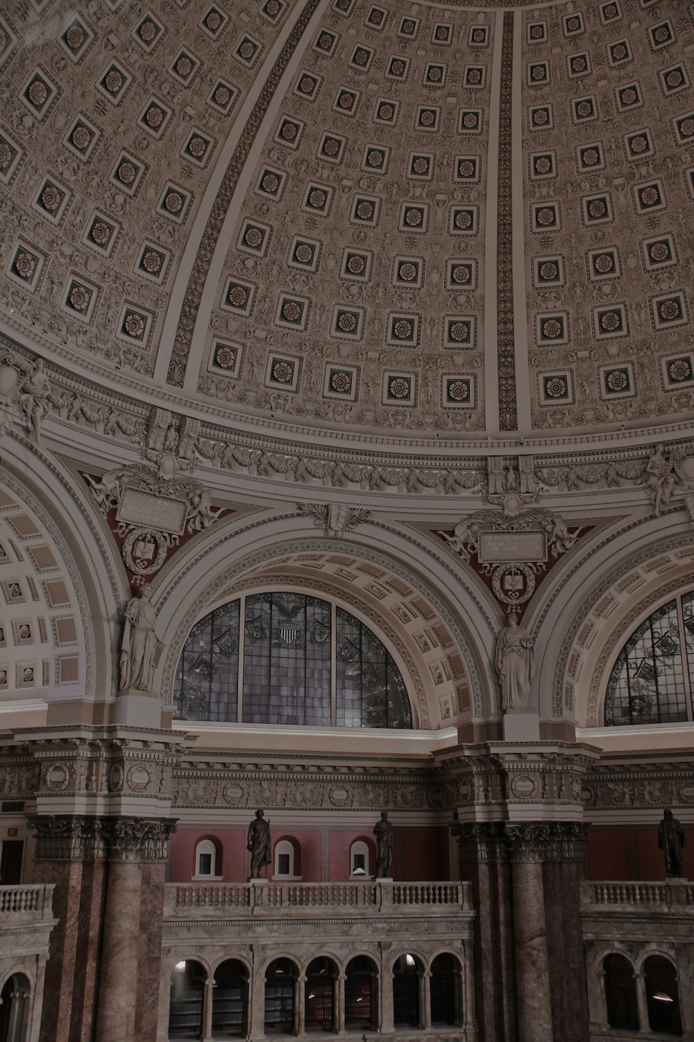 the ceiling of a large building with a clock on it