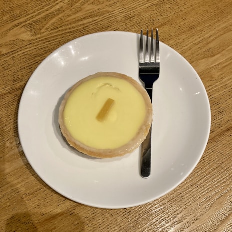 A close-up of a delicious lemon tart on a wooden table.