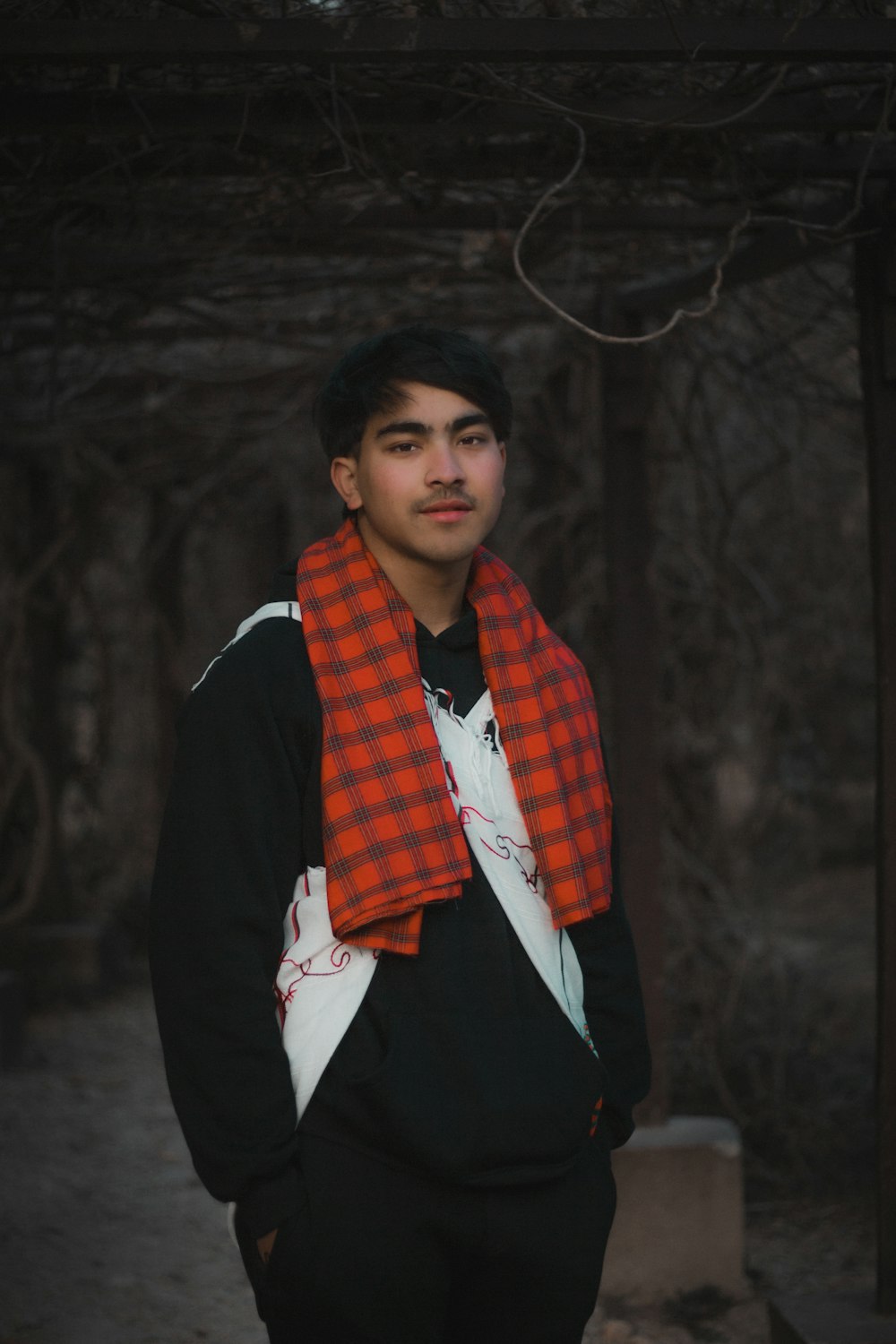 a young man wearing a red and black scarf photo – Free Nepal Image on  Unsplash