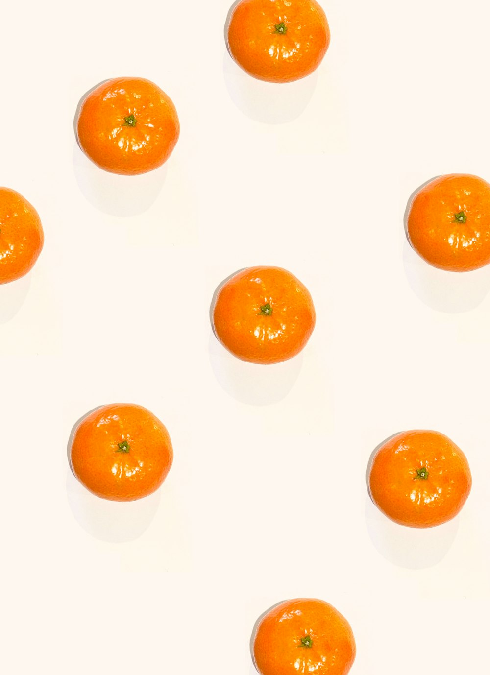 a group of oranges sitting on top of a white table