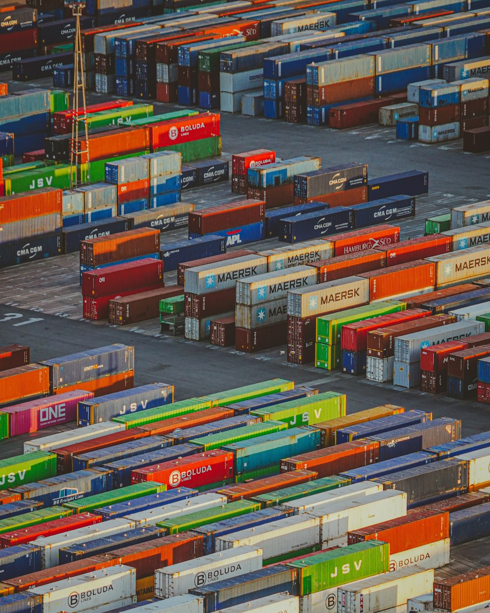 a large group of cargo containers sitting in a parking lot